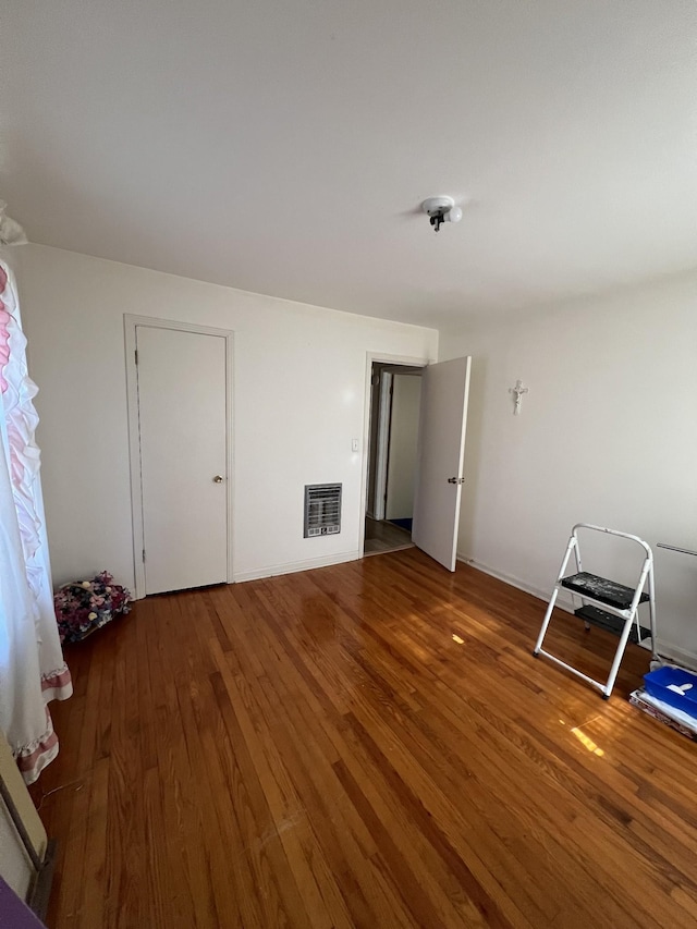 unfurnished bedroom featuring dark hardwood / wood-style flooring