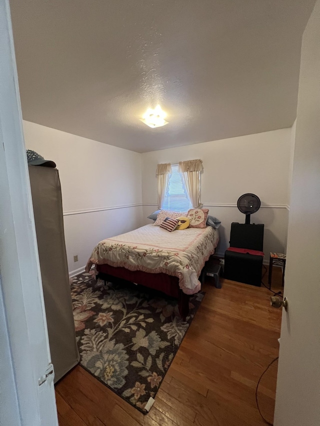 bedroom with hardwood / wood-style flooring