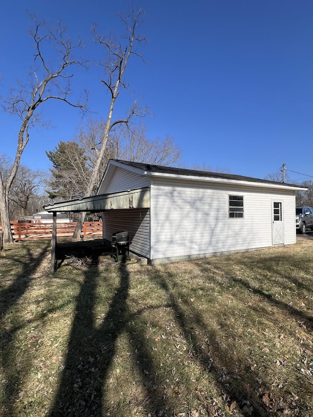 view of property exterior featuring a lawn and a carport