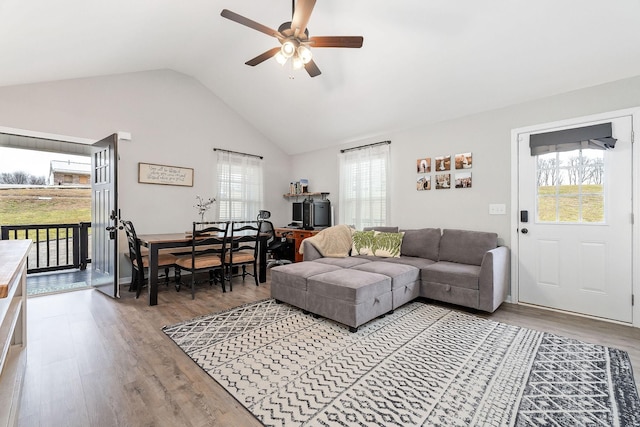 living room with hardwood / wood-style flooring, a wealth of natural light, ceiling fan, and vaulted ceiling