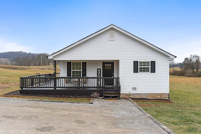 view of front of home with a front yard and covered porch