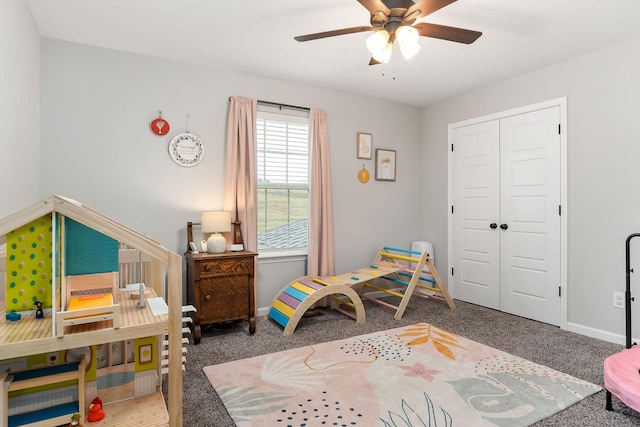 carpeted bedroom with ceiling fan and a closet