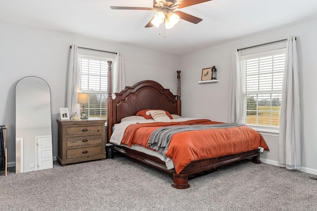 carpeted bedroom with ceiling fan and multiple windows