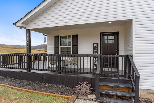 view of exterior entry with covered porch