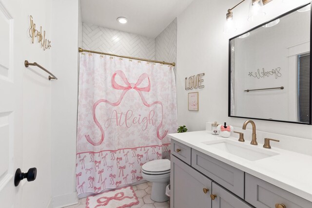 full bathroom featuring vanity, shower / tub combo with curtain, and toilet