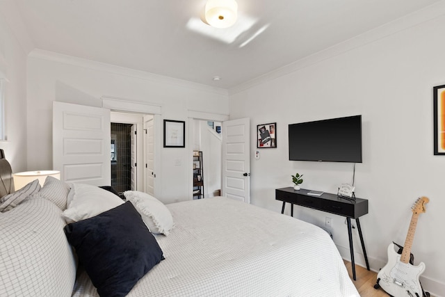 bedroom with hardwood / wood-style flooring and crown molding