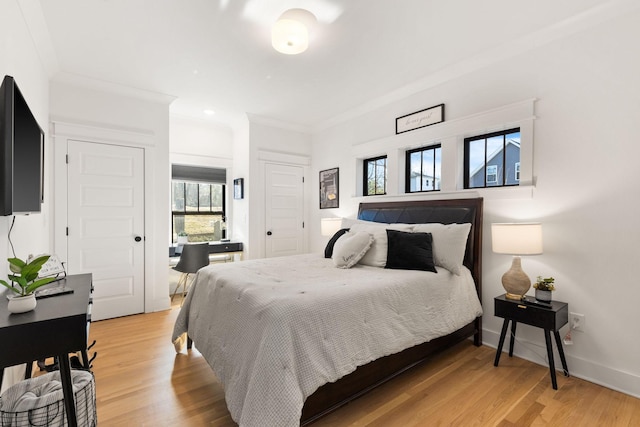 bedroom with hardwood / wood-style floors and ornamental molding