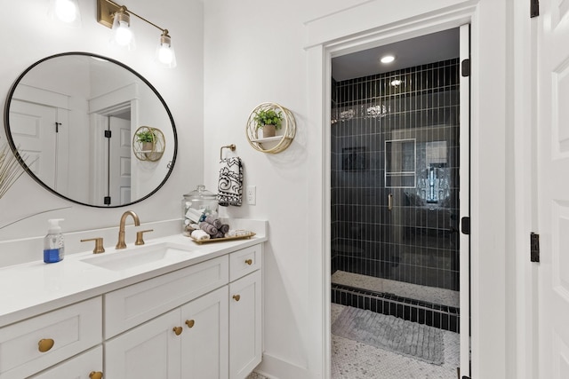 bathroom with vanity and tiled shower