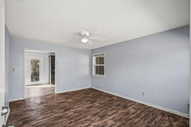 unfurnished room with ceiling fan, dark hardwood / wood-style floors, and a textured ceiling