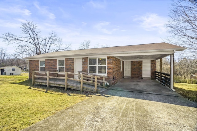 ranch-style home featuring a carport and a front lawn