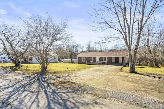 ranch-style house with a carport and a front lawn