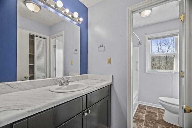 full bathroom featuring vanity, a textured ceiling, shower / bathtub combination, and toilet