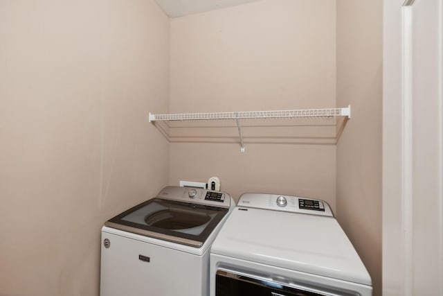 laundry area featuring washing machine and clothes dryer