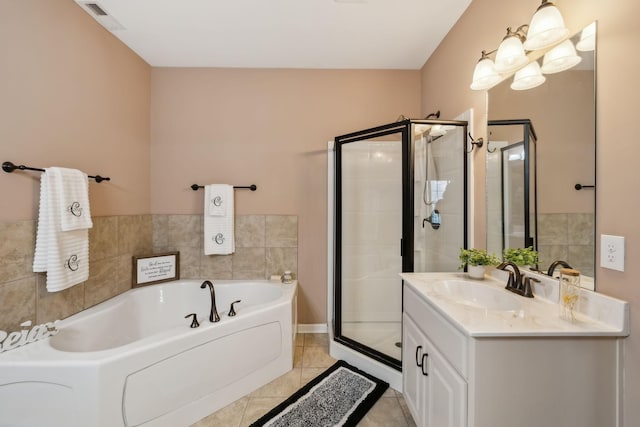 bathroom with vanity, tile patterned floors, and shower with separate bathtub