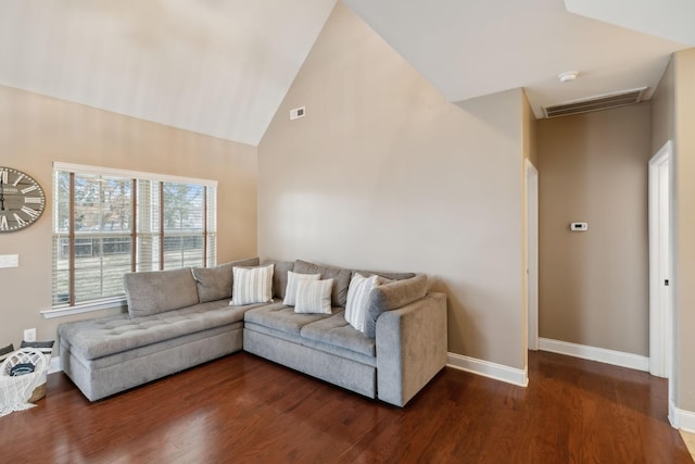 living room featuring dark hardwood / wood-style flooring and high vaulted ceiling