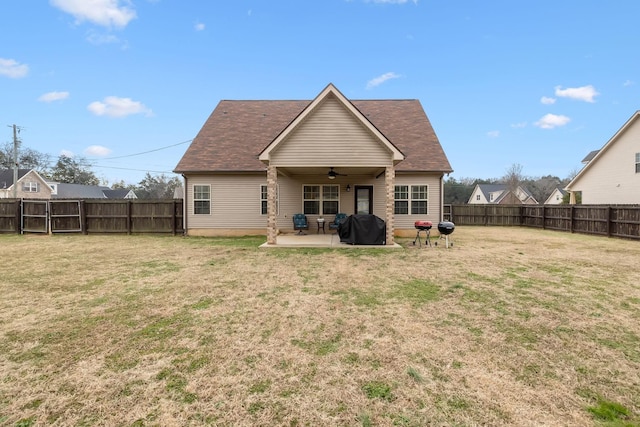 back of property with a lawn, a patio, and ceiling fan