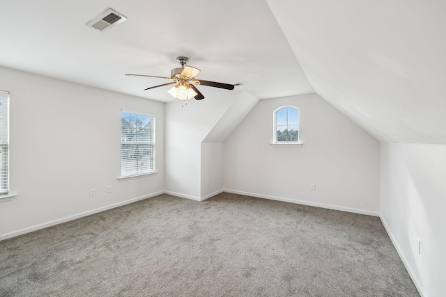 bonus room featuring ceiling fan, light colored carpet, and lofted ceiling