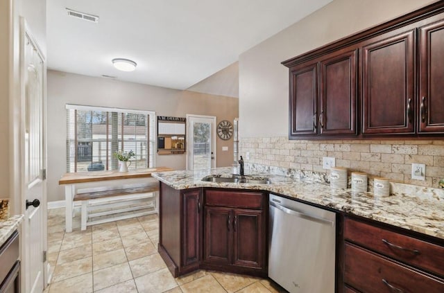 kitchen with sink, light tile patterned floors, backsplash, light stone countertops, and stainless steel dishwasher