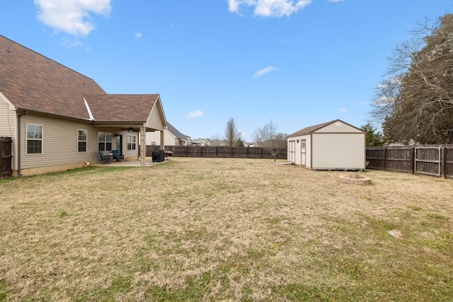 view of yard with a shed, a patio area, and ceiling fan