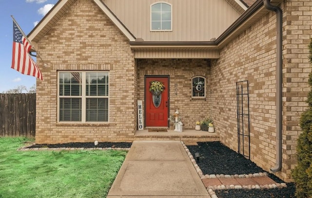 view of exterior entry with a lawn