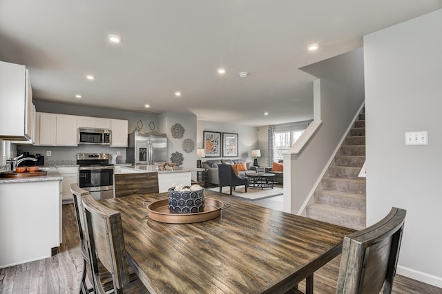 dining space with dark hardwood / wood-style floors and sink