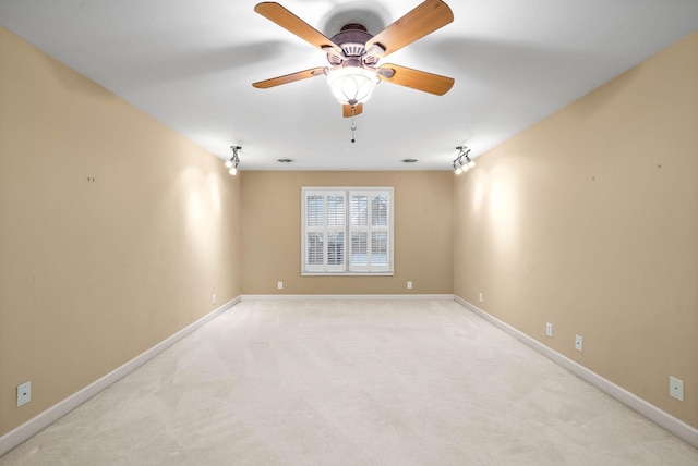 carpeted spare room with ceiling fan