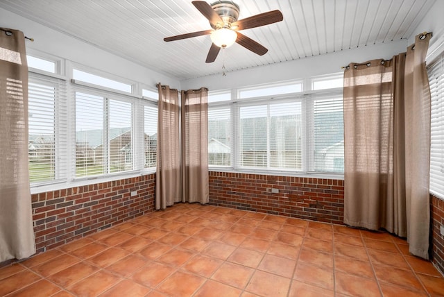 unfurnished sunroom featuring ceiling fan