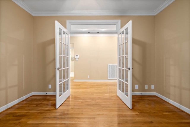 interior space featuring french doors, crown molding, and light hardwood / wood-style flooring