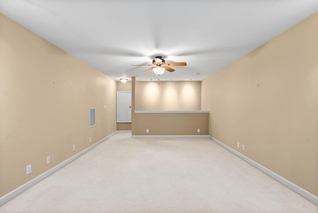 empty room featuring carpet floors and ceiling fan