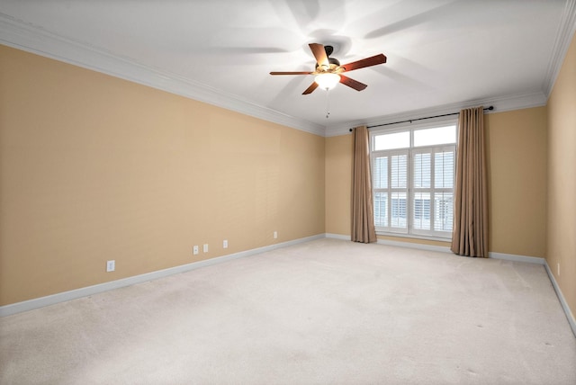 carpeted empty room featuring ornamental molding and ceiling fan