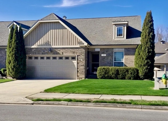 view of front of property with a garage and a front yard