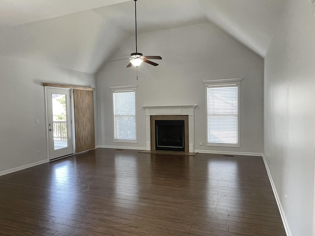 unfurnished living room featuring ceiling fan, dark hardwood / wood-style floors, and vaulted ceiling