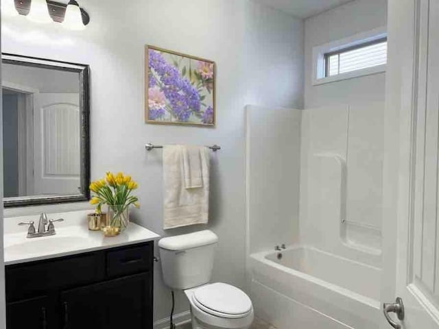 full bathroom featuring vanity, washtub / shower combination, and toilet