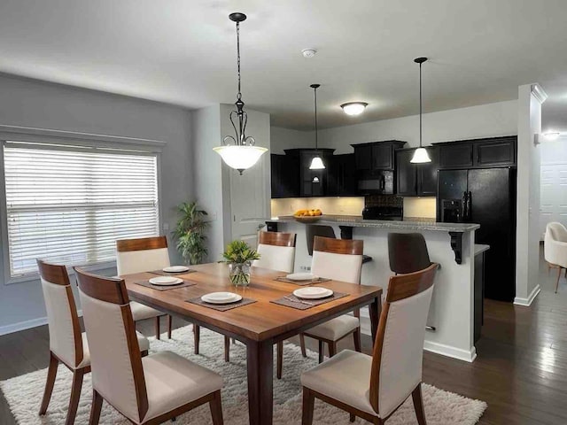 dining space featuring dark hardwood / wood-style floors