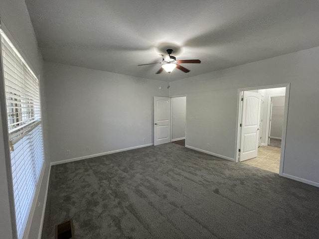 unfurnished bedroom featuring carpet floors and ceiling fan