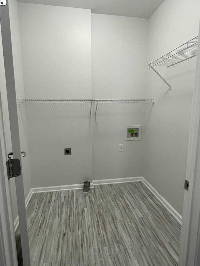 washroom with electric dryer hookup, hardwood / wood-style floors, and hookup for a washing machine