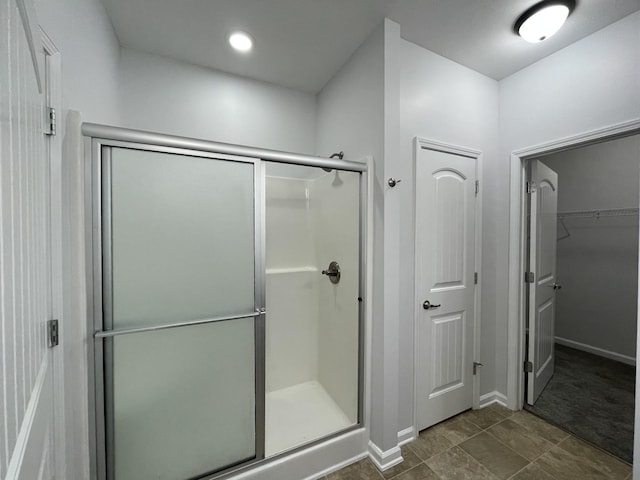 bathroom with a shower with door