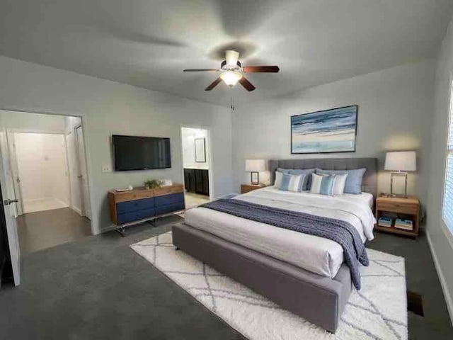 carpeted bedroom featuring ceiling fan and ensuite bath