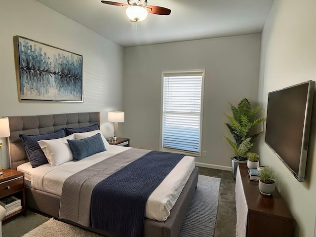 bedroom featuring dark carpet and ceiling fan