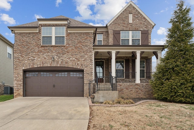 view of front of home with a garage, a porch, and central AC unit