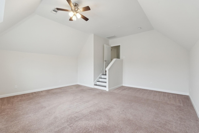 additional living space with vaulted ceiling, light carpet, and ceiling fan