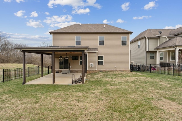 rear view of house with a lawn and a patio