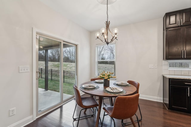 dining area featuring an inviting chandelier and dark hardwood / wood-style floors