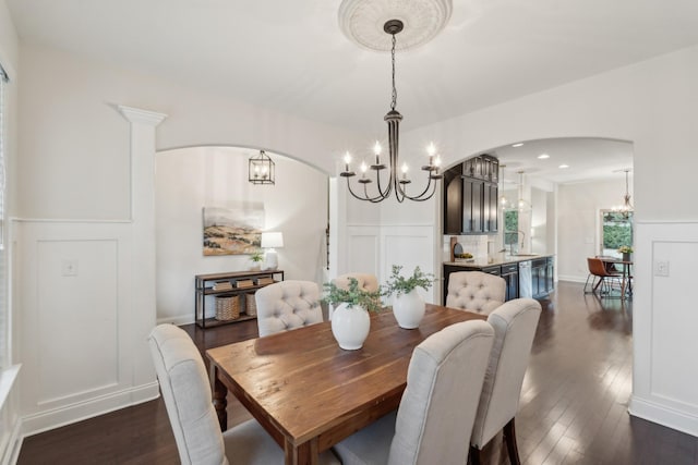 dining space with dark hardwood / wood-style floors and sink