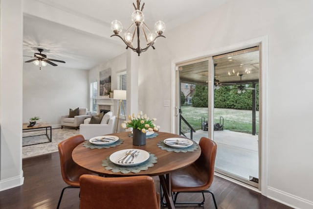 dining room featuring dark wood-type flooring and ceiling fan with notable chandelier