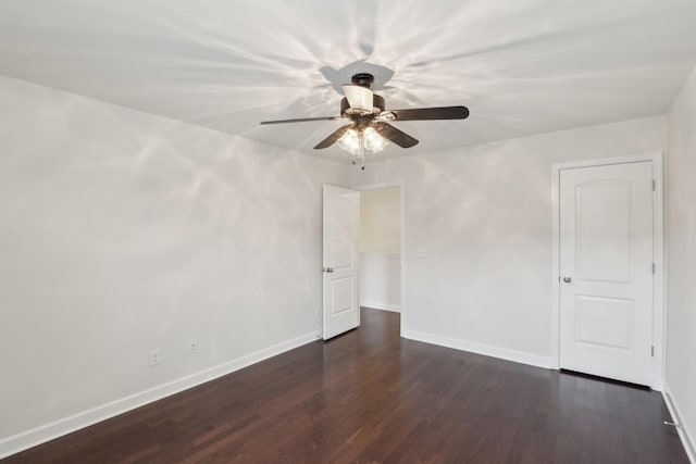 unfurnished room with dark hardwood / wood-style flooring and ceiling fan