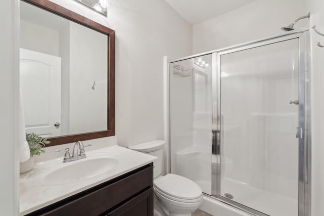 bathroom featuring vanity, toilet, and walk in shower