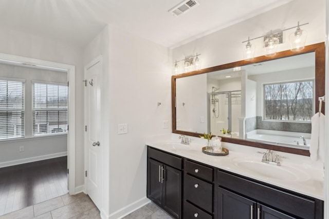 bathroom with vanity, a wealth of natural light, tile patterned floors, and independent shower and bath