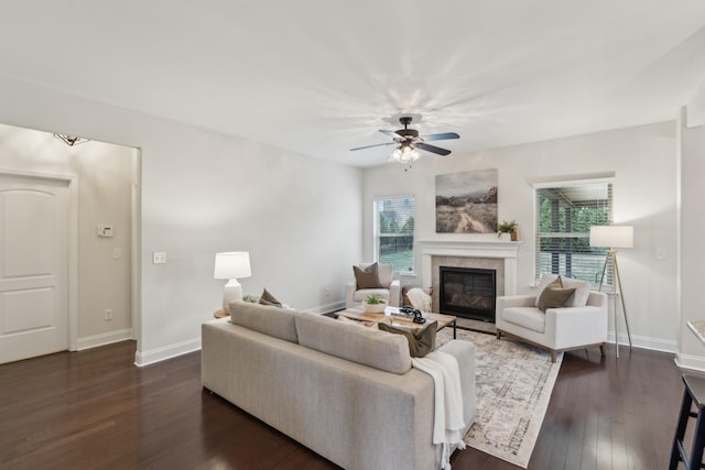 living room featuring a tile fireplace, ceiling fan, and dark hardwood / wood-style flooring