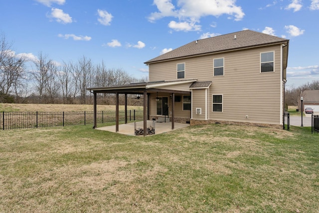 rear view of house featuring a yard and a patio